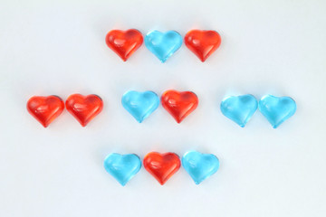 Blue and red glass hearts  on white background. Stock photo for Valentine's Day with empty place for text. For web, print, cards, invitations, wallpaper.