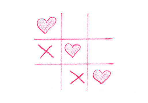 Game tic-tac-toe with hearts. The concept of victory of love. Red hearts and crosses on a white isolated background. Valentine's Day stock photo for web, print, cards, invitations, background.