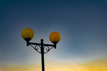 Bright and colorful lights on the waterfront at dusk and night, seascape, green and yellow light,...