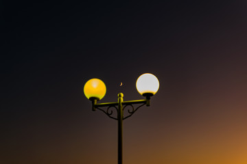 Bright and colorful lights on the waterfront at dusk and night, seascape, green and yellow light,...
