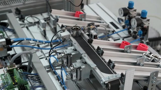 Close-up of product which automatically classified according to color in storage station. Handling and Sorting Application. Industry 4.0 concept; artificial intelligence in autonomous production.