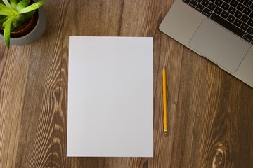 Dark wood work table with paper and pencil for notes