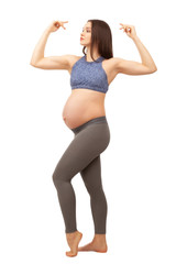 The pregnant woman in a sports suit on a white background.