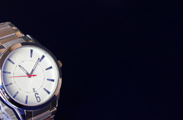 Modern wristwatch standing on nice dark background with copy space