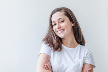 Fototapeta premium Happy girl smiling. Beauty portrait young happy positive laughing brunette woman on white background isolated. European woman. Positive human emotion facial expression body language