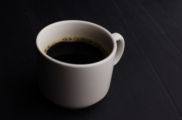 Black closeup on dark backdrop. Coffee espresso on dark background.