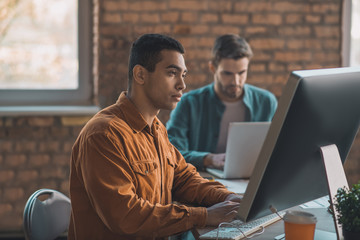 Handsome smart man looking at the computer screen