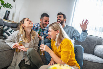 Group of friends enjoying soccer on TV