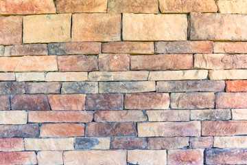 Fototapeta premium Stone Wall Closeup Blocks Brick Slate Red Brown Earth Design Background