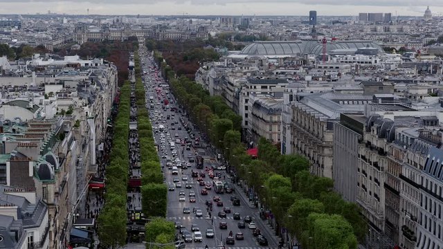 Aerial view looking down a busy Avenue des Champs-Elysee towards the Musee du Louvre, Paris, France. Handheld static wide shot