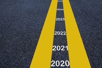 Number of 2020 to 2025 on asphalt road surface with marking lines, happy new year concept and...
