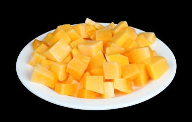 Slices of sweet orange pumpkin on a white  plate  isolated black