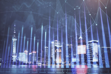 Financial graph on night city scape with tall buildings background double exposure. Analysis concept.