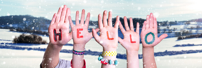 Children Hands Building Colorful Word Hello. Snowy Winter Background With Snowflakes © Nelos