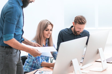 Obraz premium business team discussing working documents in a light office.