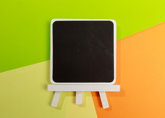 Easel with frames empty for drawing on colored background. - Image