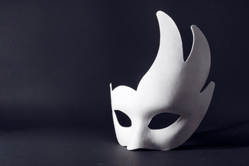 white carnival mask on a black background. concept of carnival, holiday, festival..
