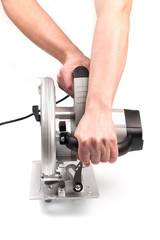 Electric circular saw holding by mans hands .Circular saw is designed for cutting wood and plastic. Object is isolated on white background - Image