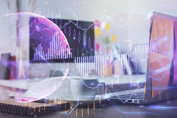 Financial graph colorful drawing and table with computer on background. Double exposure. Concept of international markets.