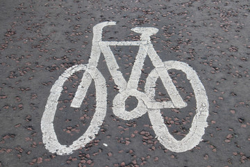 Painted cycle path bicycle sign on the ground in dedicated cycle lane path
