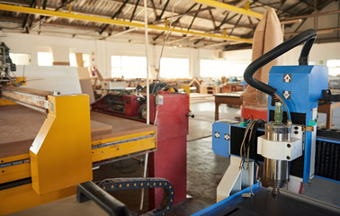 Large industrial machinery inside of a woodworking shop