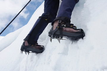 Mountain climber on snowy slope low section