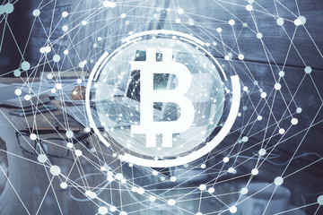 Double exposure of blockchain theme hologram and table with computer background. Concept of bitcoin crypto currency.