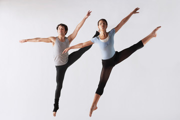 Two attractive ballerinas practising in the studio together