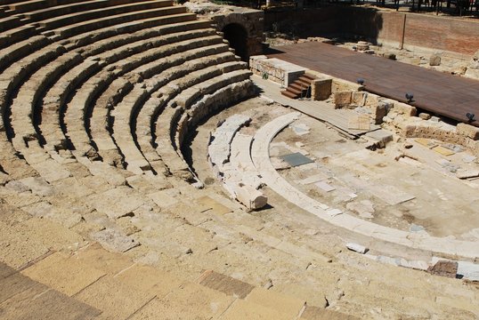 View of the Roman Amphitheatre seating area and stage in the city centre, Malaga, Spain.