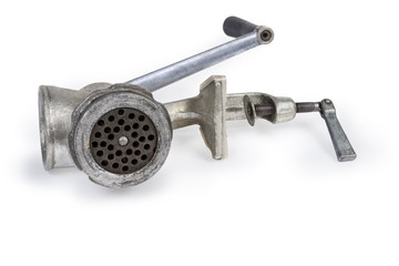 Old hand meat grinder on a white background