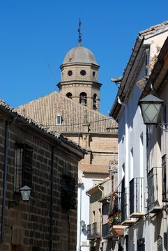 View of the Cathedral bell tower seen at the end of an old town street, Baeza, Spain.
