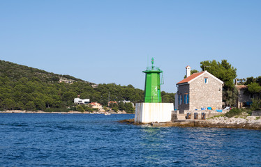 Fototapeta na wymiar lighthouse at the entrance to the harbor of Mali Losinj, Croatia.