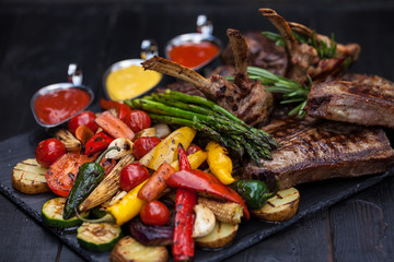 grilled set of steaks, t-bone and vegetables