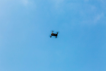 quadrocopter in the blue sky with clouds