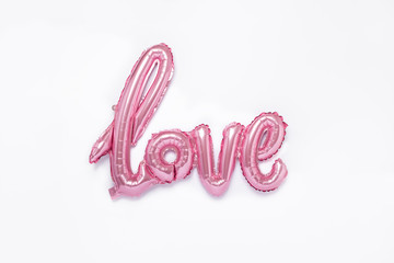 Pink balloons in the form of word Love on white background. Valentines day celebration.