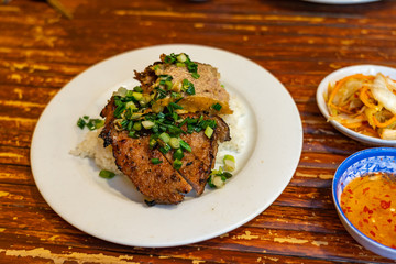 Vietnamese pork chop rice served with pickles and fish sauce
