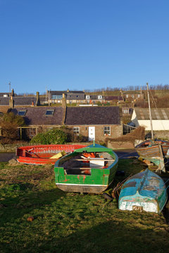 Wooden Fishing boats in storage for Winter on the Village Green next to the Harbour in the Coastal Village of Johnshaven.