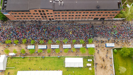 Marathon running race, aerial view of start and finish line with many runners from above, road...