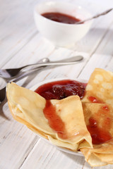 Thin pancakes with strawberry jam