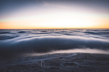 Winter landscape in Krkonose, beautiful sunrise with moon above the heavy clouds, shot from highest...