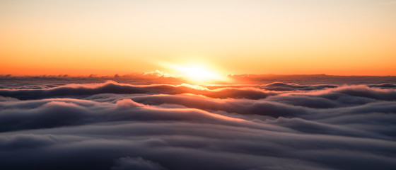 Winter landscape in Krkonose, beautiful sunrise with moon above the heavy clouds, shot from highest mountain in Czech republic called Snezka.