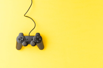 Overhead shot of video game console on yellow background with copyspace. Computer player concept