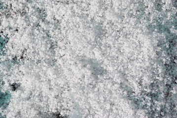 Grainy texture snow, natural background, close up detail top view