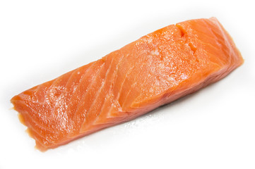 A piece of salted salmon close-up. Red fish on a white background