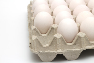 Isolated recycle tray with white eggs on a white background. Tray without one egg