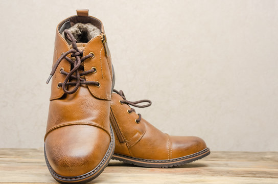 Brown leather men's shoes on a wooden background