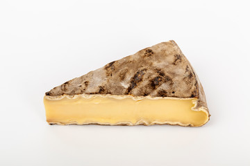 french cow's milk cheese called saint-nectaire isolated on white background