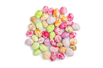 Pile of multicolored chocolate candies isolated on white background. close up, top view.