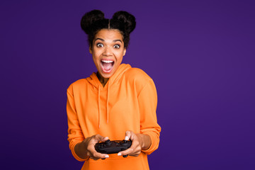 Portrait of her she nice attractive lovely cheerful cheery brunette girl wearing hoody playing online game having fun isolated over bright vivid shine vibrant lilac violet purple color background © deagreez