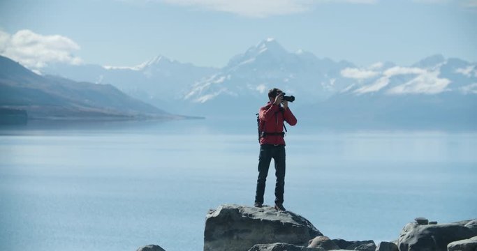 Travel blogger taking photographs in New Zealand. Lake with Mt Cook in background. Video clip recorded on professional camera, 10bit Pro Res in slo-motion.